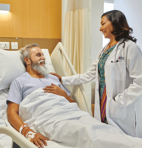 Doctor smiling and speaking with a patient